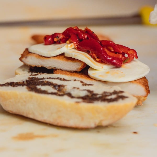 Italian sandwich with breaded chicken, fresh mozzarella, roasted red peppers, and olive spread.