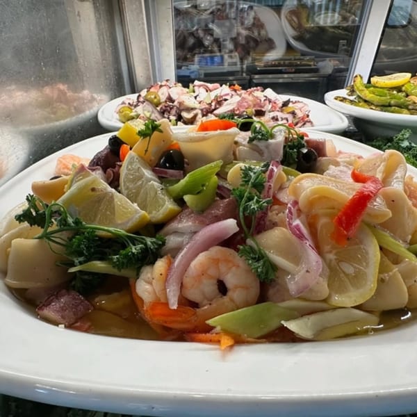 A vibrant Italian seafood salad with shrimp, calamari, octopus, lemon, and herbs.
