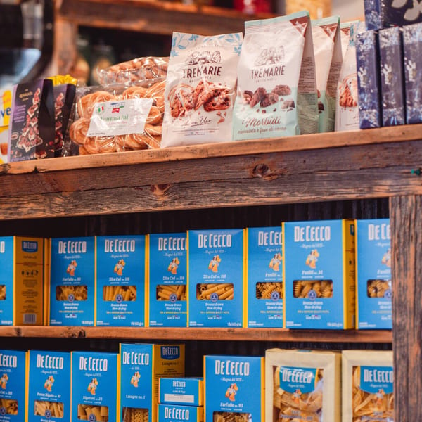 Shelves filled with various Italian dry pasta boxes and packaged baked goods at Taste of Italy.